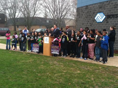 Attorney General Van Hollen and Michael Johnson of the Boys & Girls Club of Dane County deliver remarks before displaying pinwheels in front of the Boys & Girls Club of Dane County--Allied Family Center in Fitchburg