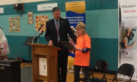 During the poster contest award ceremony, AG Van Hollen also presented Maya Schmidtke, a 4th grade student at Jefferson Elementary School, with a certificate from the DOJ and a certificate from Governor Scott Walker for winning a statewide spelling bee organized by the Boys and Girls Club.